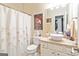 Bright bathroom with a vessel sink, decorative shower curtain, and natural light at 512 Las Brasis Ct, Peachtree City, GA 30269