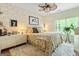 Comfortable bedroom with a unique design, featuring neutral tones, a ceiling fan, and ample natural light at 512 Las Brasis Ct, Peachtree City, GA 30269