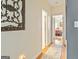 Inviting hallway with decorative wall art and a view into a sunlit bedroom at 512 Las Brasis Ct, Peachtree City, GA 30269