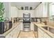 Bright kitchen with white cabinets, granite countertops, and stainless steel appliances at 512 Las Brasis Ct, Peachtree City, GA 30269
