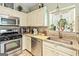 Well-appointed kitchen featuring stainless steel appliances, granite countertops, and ample natural light at 512 Las Brasis Ct, Peachtree City, GA 30269