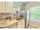 Charming kitchen features modern appliances, light countertops, and a sunny window with plants at 512 Las Brasis Ct, Peachtree City, GA 30269