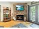 Living room with hardwood floors, fireplace, and views of the backyard through patio doors at 512 Las Brasis Ct, Peachtree City, GA 30269