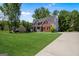 Beautiful brick home featuring a lush lawn, driveway, and lovely landscaping at 419 Tea Rose N Ln, Stockbridge, GA 30281