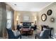 Cozy living room with a comfortable seating arrangement, complemented by elegant decor and natural light at 419 Tea Rose N Ln, Stockbridge, GA 30281