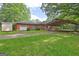 Backyard with a garage and carport, mature shade trees, and green grass at 2742 Highway 20 W, Hampton, GA 30228