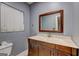 Bathroom features a dark wood vanity, mirror, white countertop, and a window at 2742 Highway 20 W, Hampton, GA 30228