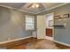 Bedroom with hardwood floors, ceiling fan, window, and gray walls, opens to the bathroom at 2742 Highway 20 W, Hampton, GA 30228