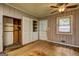 Neutral bedroom featuring hardwood floors, a ceiling fan, a closet, and natural light at 2742 Highway 20 W, Hampton, GA 30228