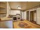 Spacious kitchen featuring hardwood floors, washer-dryer, white cabinetry, and ample counter space at 2742 Highway 20 W, Hampton, GA 30228