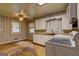 Kitchen featuring hardwood floors, neutral walls, a ceiling fan, and white cabinetry with ample counter space at 2742 Highway 20 W, Hampton, GA 30228