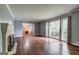 Bright living room featuring hardwood floors, fireplace and large windows at 2742 Highway 20 W, Hampton, GA 30228