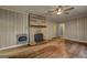 Unique living room showcasing the stone fireplace, ceiling fan and hardwood floors at 2742 Highway 20 W, Hampton, GA 30228