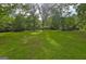 Expansive front yard view with mature trees at 2742 Highway 20 W, Hampton, GA 30228