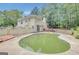 Backyard view of the home featuring a large pool surrounded by greenery at 70 N Strathmore Dr, Sharpsburg, GA 30277