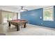 Spacious basement area features a pool table, tile flooring, and neutral paint at 70 N Strathmore Dr, Sharpsburg, GA 30277