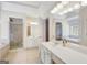 Bright bathroom showcasing white vanities, glass shower, and a soaking tub at 70 N Strathmore Dr, Sharpsburg, GA 30277
