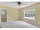 Bedroom with carpeted floor, fan and a large window overlooking the front yard at 70 N Strathmore Dr, Sharpsburg, GA 30277