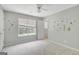 Bedroom has light-gray carpet, bright walls, and a fan to keep the space cool at 70 N Strathmore Dr, Sharpsburg, GA 30277