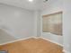 Bedroom with light wood floors and a large window with blinds at 70 N Strathmore Dr, Sharpsburg, GA 30277