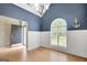 A dining room with blue walls, white trim and large window allows plenty of natural light at 70 N Strathmore Dr, Sharpsburg, GA 30277
