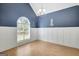 A dining room with blue walls, white trim and large window allows plenty of natural light at 70 N Strathmore Dr, Sharpsburg, GA 30277