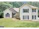 Charming two-story home with vinyl siding and a stone facade and manicured lawn at 70 N Strathmore Dr, Sharpsburg, GA 30277