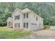 View of the vinyl siding and a stone facade, garage and manicured lawn at 70 N Strathmore Dr, Sharpsburg, GA 30277