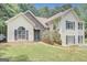 Charming two-story home with vinyl siding and a stone facade and manicured lawn at 70 N Strathmore Dr, Sharpsburg, GA 30277