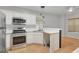 Kitchen featuring stainless steel appliances, wood cabinets and a breakfast bar at 70 N Strathmore Dr, Sharpsburg, GA 30277