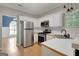 Updated kitchen featuring white cabinets and stainless steel appliances at 70 N Strathmore Dr, Sharpsburg, GA 30277