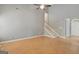 Living room with light wood floors leading to a staircase and front door at 70 N Strathmore Dr, Sharpsburg, GA 30277