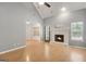 Open living room with vaulted ceiling, fireplace and light wood floors at 70 N Strathmore Dr, Sharpsburg, GA 30277