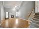 Living Room featuring hardwood floors, fireplace, staircase and plenty of natural light at 70 N Strathmore Dr, Sharpsburg, GA 30277