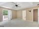 Spacious main bedroom featuring tray ceiling, fan, and private patio access at 70 N Strathmore Dr, Sharpsburg, GA 30277