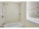 Tiled shower and tub area with a window provides ample natural light at 70 N Strathmore Dr, Sharpsburg, GA 30277