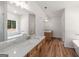 Bathroom with white marble countertops, and a large soaking tub at 4585 Parkwood Rd, Social Circle, GA 30025