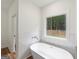 Bright bathroom featuring a modern soaking tub at 4585 Parkwood Rd, Social Circle, GA 30025