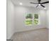 Bright bedroom features a ceiling fan and scenic views through the double window at 4585 Parkwood Rd, Social Circle, GA 30025