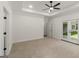 Large primary bedroom features plush carpet and door to backyard at 4585 Parkwood Rd, Social Circle, GA 30025