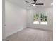 Bright bedroom with plush carpeting, modern ceiling fan, and energy-efficient windows at 4585 Parkwood Rd, Social Circle, GA 30025
