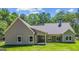 Craftsman style home with lush green backyard and covered patio at 4585 Parkwood Rd, Social Circle, GA 30025
