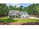 Inviting light blue two-story home with a covered front porch and pristine landscaping at 4585 Parkwood Rd, Social Circle, GA 30025