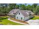 A well-maintained, light blue two-story home with an attached garage and a lush green lawn at 4585 Parkwood Rd, Social Circle, GA 30025