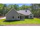 Beautiful back exterior of a craftsman style home with lush green backyard at 4585 Parkwood Rd, Social Circle, GA 30025