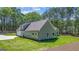 New construction showing exterior home with lush green backyard and attached garage at 4585 Parkwood Rd, Social Circle, GA 30025