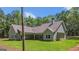 Stunning backyard view of a craftsman style home with lush green lawn at 4585 Parkwood Rd, Social Circle, GA 30025