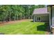 Lush green backyard showing patio and doors leading into the house at 4585 Parkwood Rd, Social Circle, GA 30025