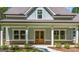 Close-up of a charming front porch with a double door entry and brick accents at 4585 Parkwood Rd, Social Circle, GA 30025