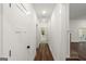 Hallway with hardwood floors, white trim, leading to rooms at 4585 Parkwood Rd, Social Circle, GA 30025
